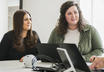 Two team members work together in the Denver office Two team members work together in the Denver office