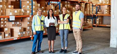 Four team members in a warehouse