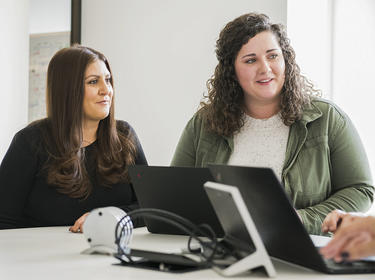 Two team members work together in the Denver office
