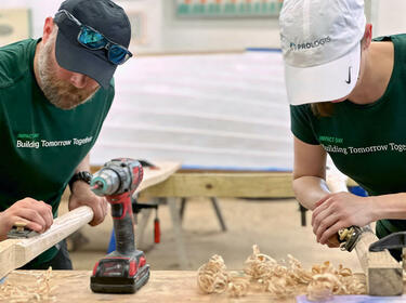 Två Prologis-medarbetare som slipar trä under ett IMPACT Day-projekt Två Prologis-medarbetare som slipar trä under ett IMPACT Day-projekt