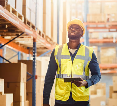 A man in a warehouse checking inventory A man in a warehouse checking inventory