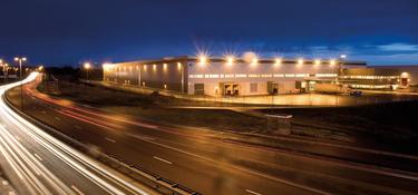 Logistics Facility next to a highway in the dark